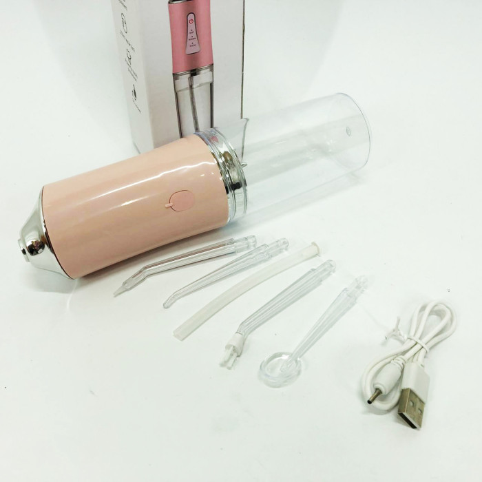 Іригатор для чищення зубів та порожнини рота Oral Irrigator з акумулятором та змінними насадками. Колір: рожевий