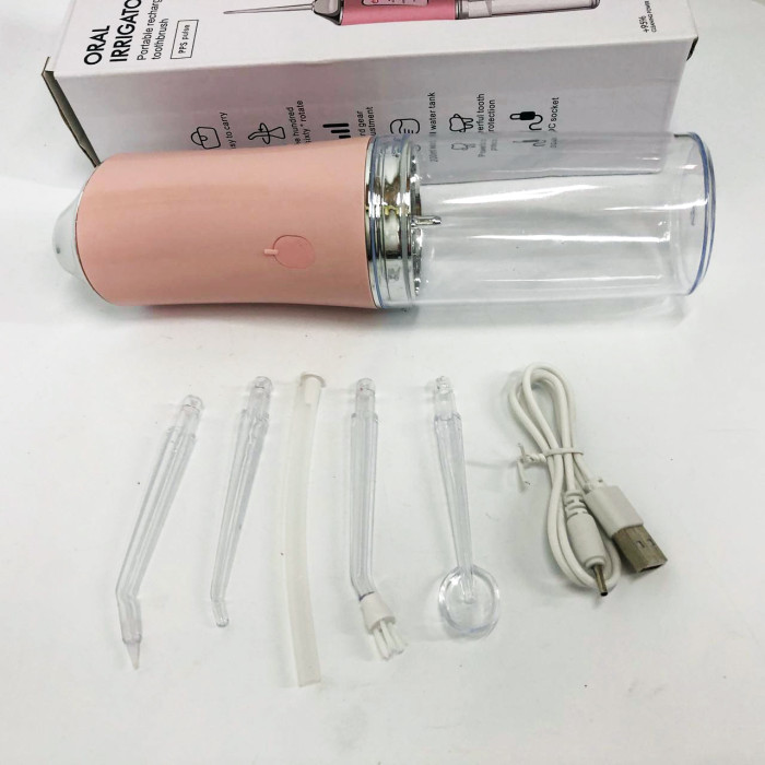 Іригатор для чищення зубів та порожнини рота Oral Irrigator з акумулятором та змінними насадками. Колір: рожевий